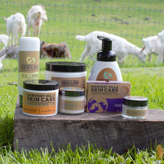 Goat milk skin care products with our goats in the background