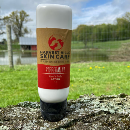 Harvest Hills Skin Care peppermint lotion bottle on a tree stump with a natural background