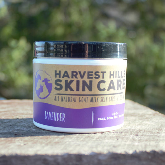 Jar of Harvest Hills Skin Care lavender product on a wooden surface with a blurred green background