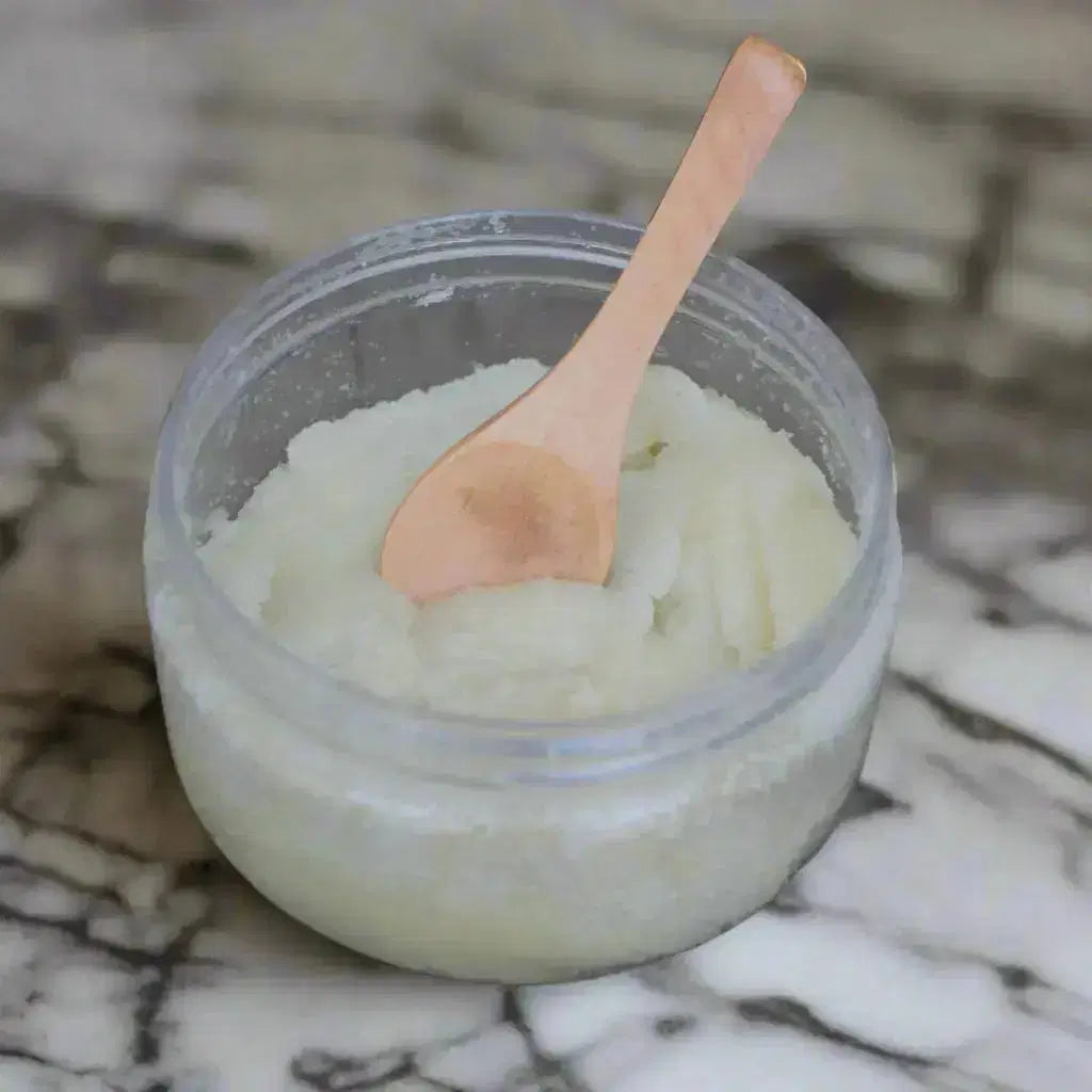 Jar of white cream with a wooden spoon on a rustic wooden surface