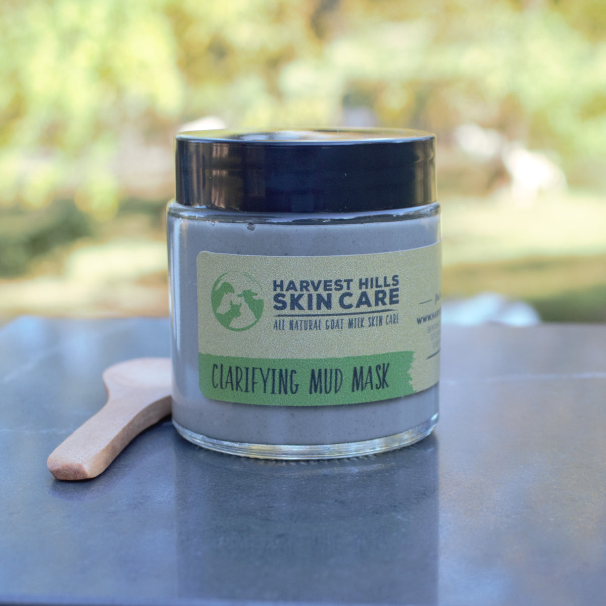 clarifying mud mask in glass jar with small wooden spoon