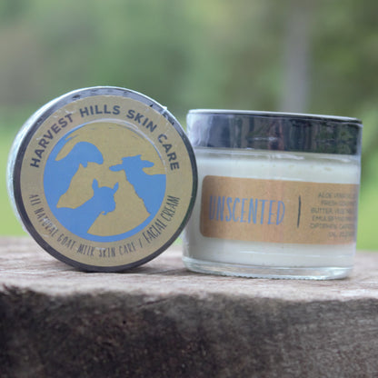 Jars Unscented goat milk face cream on wood outdoors