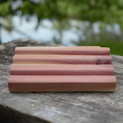 cedar soap tray on wood with natural green background