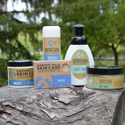 A set of Harvest Hills Unscented goat milk skin care including, a bar of soap, jar of intensive moisturizer, sugar body scrub, Tube of goat milk lotion, bottle of foaming liquid goat milk soap