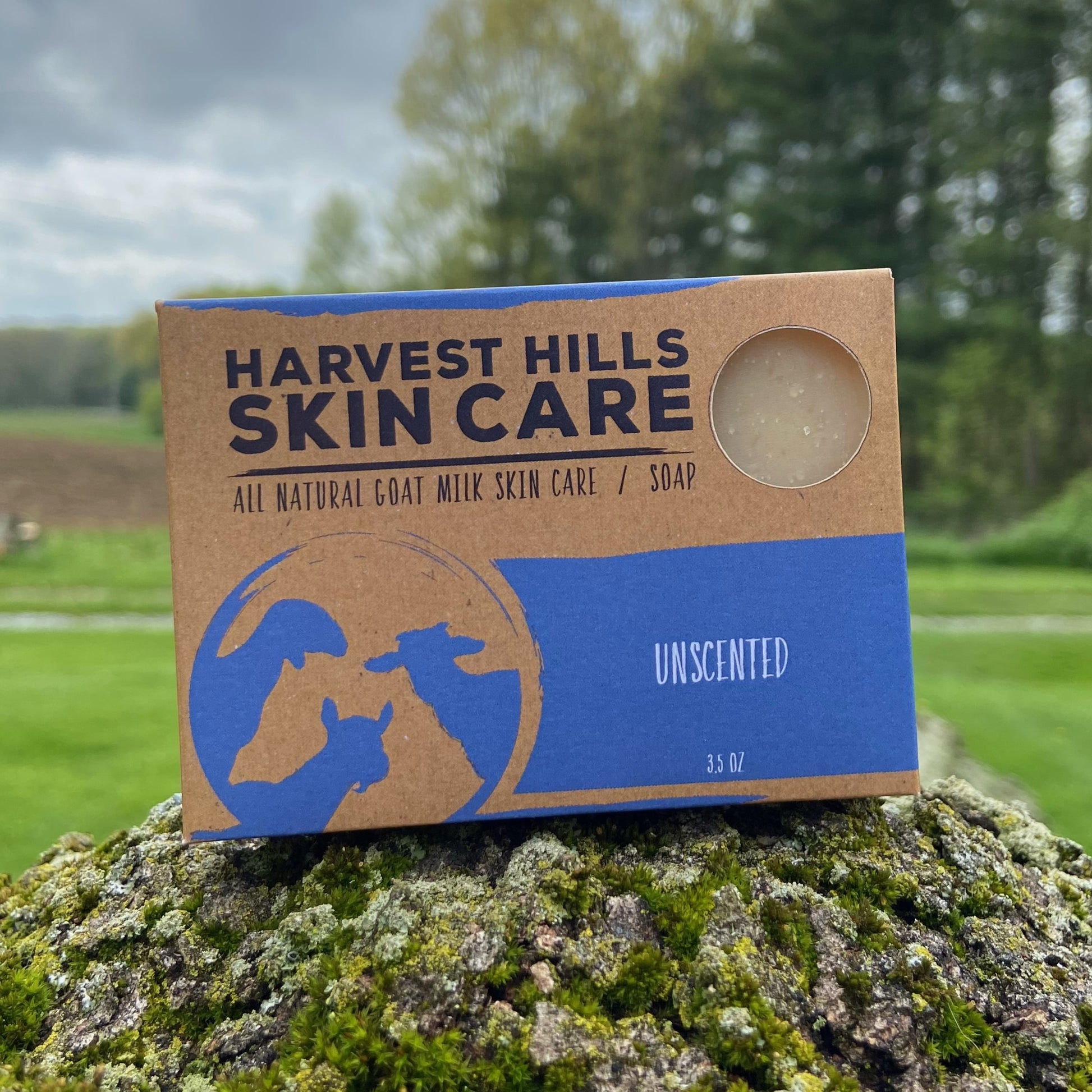 Harvest Hills Skin Care unscented goat milk soap bar on a rock with a natural background